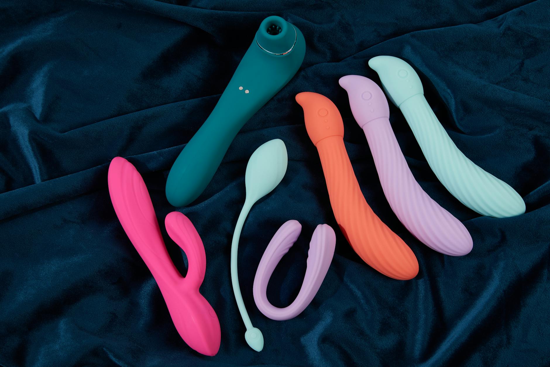 Hand holding a lemon vibrator against a minimalist backdrop, showcasing suction stimulation technology