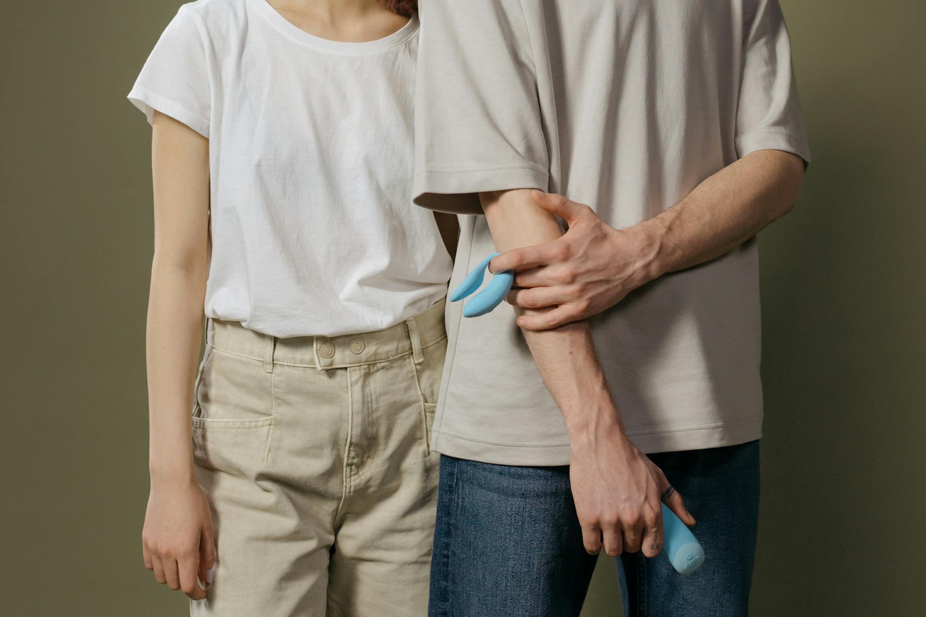Hand holding a lemon against a bright yellow background, representing the gentle yet effective technology of lemon vibrators