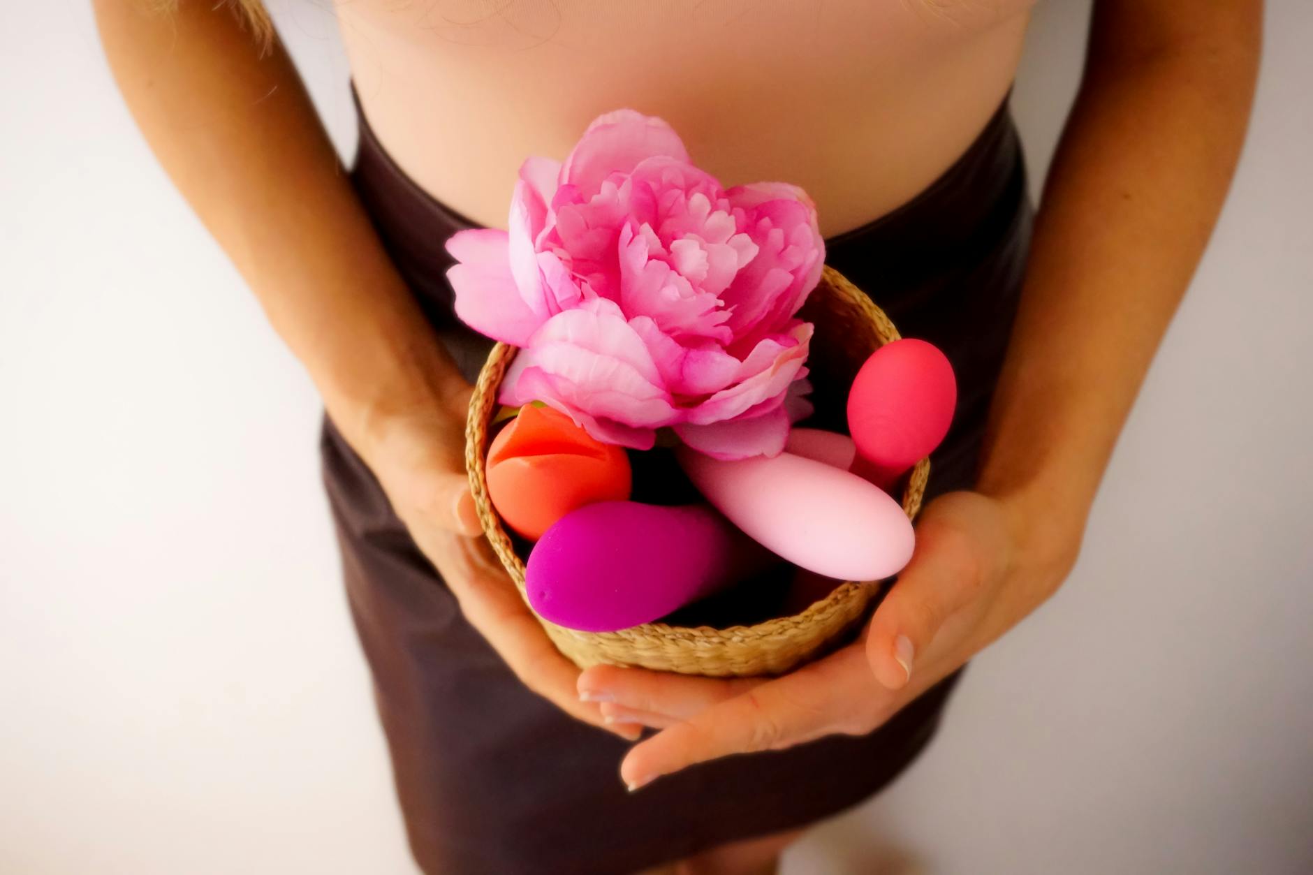 Vibrant arrangement of colorful lemon vibrators and adult toys on a bright yellow surface